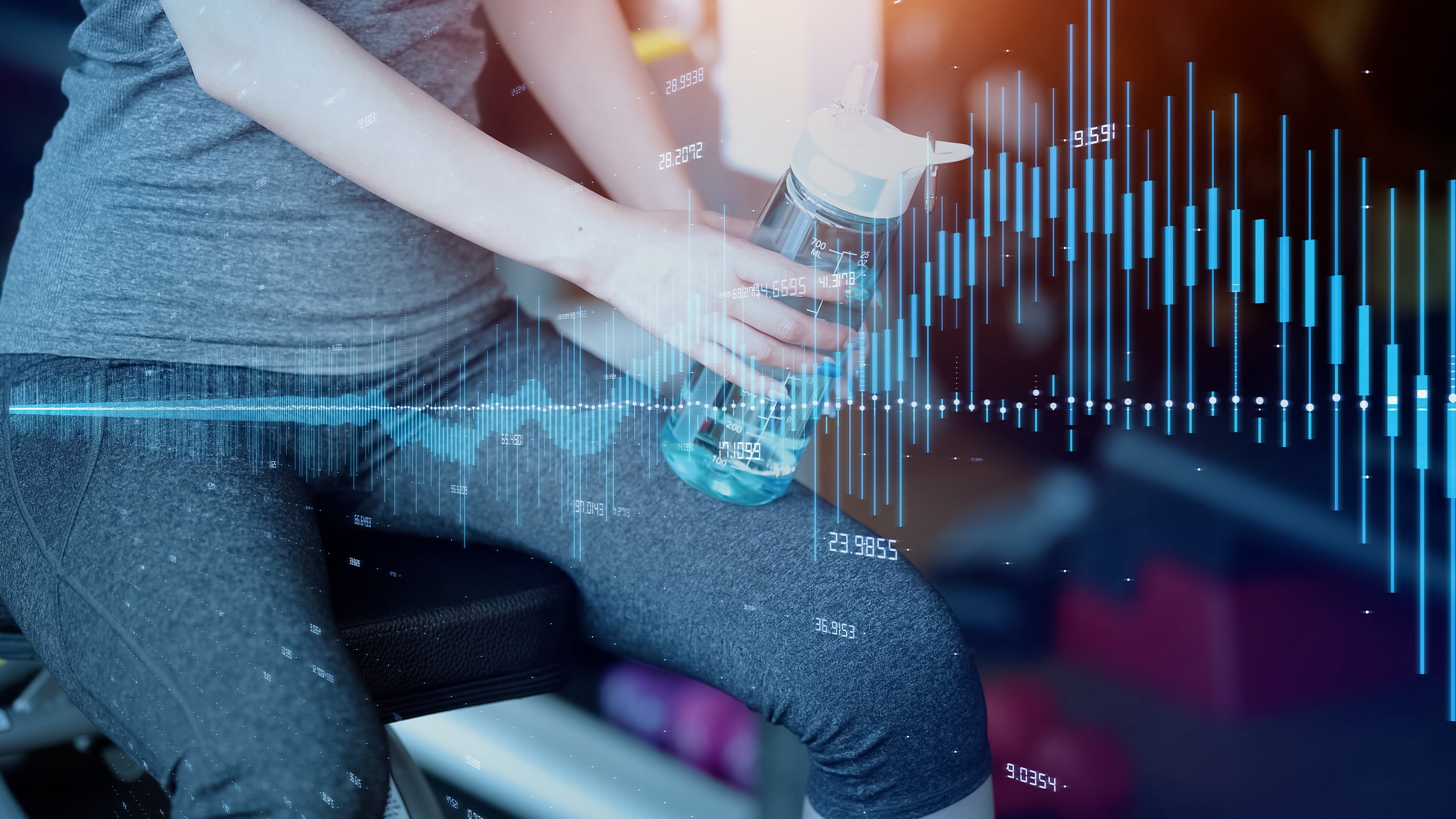 A photo of a woman sat on an exercise bench with a water bottle in her hand. Biorhythm graphics are overlaid for visual representation.